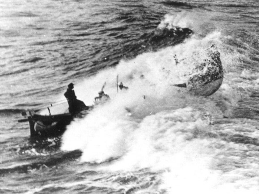 Photo of lifeboat breaking the waves, with writing “Life boat in surf No. 12, Brown”