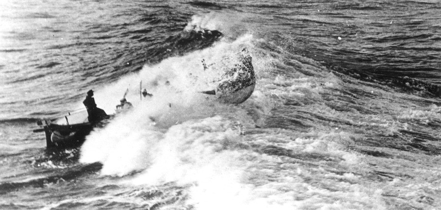 Photo of lifeboat breaking the waves, with writing “Life boat in surf No. 12, Brown”