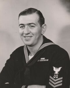 An official portrait photograph of BM1 Bernie Webber in his dress blues.