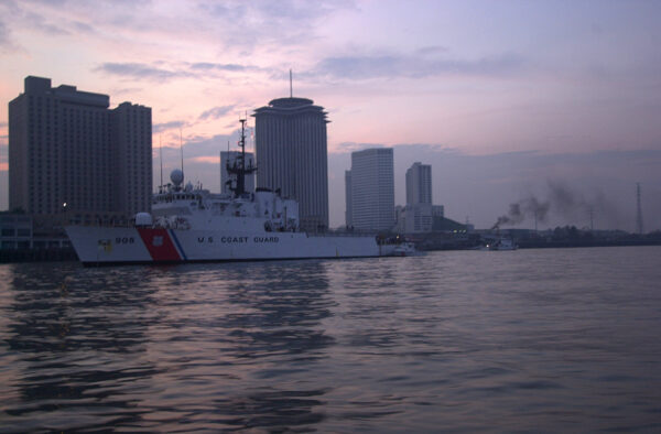 Photo: A Coast Guard cutter sits at anchor in the twilight near the downtown.