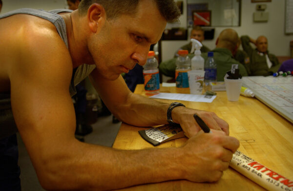 Photo: Air crewmember autographs an ax.