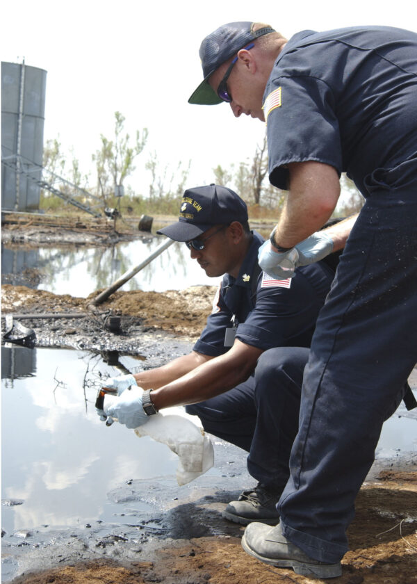 Photo: Coast Guardsmen take water samples.