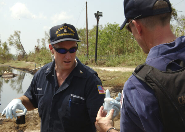 Photo: U.S. Coast Guard Chief Phillip Jenicek of Sector New Orleans and Edward Primeau of Atlantic Strike Team take samples at the Sundown East Oil Facility.