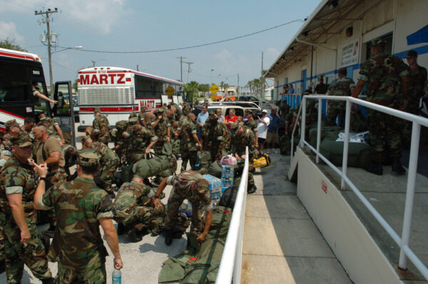 Photo: Port security teams begin boarding busses at a Coast Guard station.