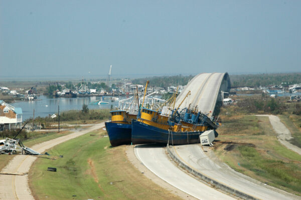 Photo: Two ships sit on the highway, blocking a bridge.