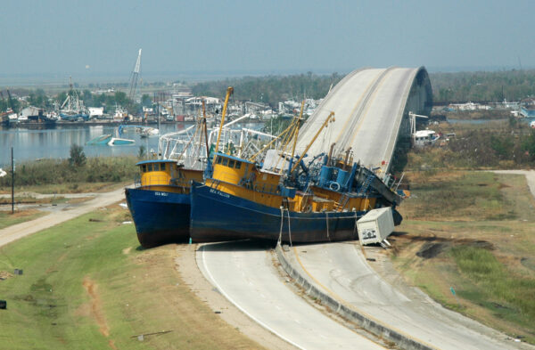Photo: Two ships sit on the highway, blocking a bridge.