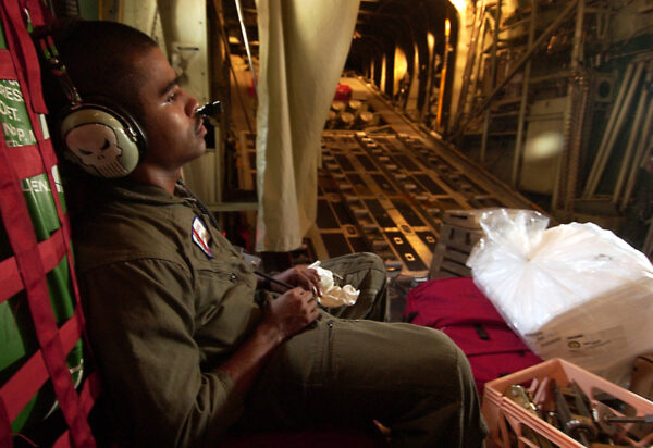Photo: A Coast Guardsman takes advantage of a flight to rest.