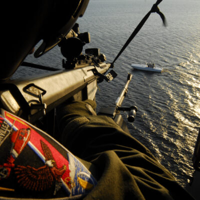 Photo: Gunner takes aim at a fast boat with a decommissioned .50 caliber precision rifle during training.