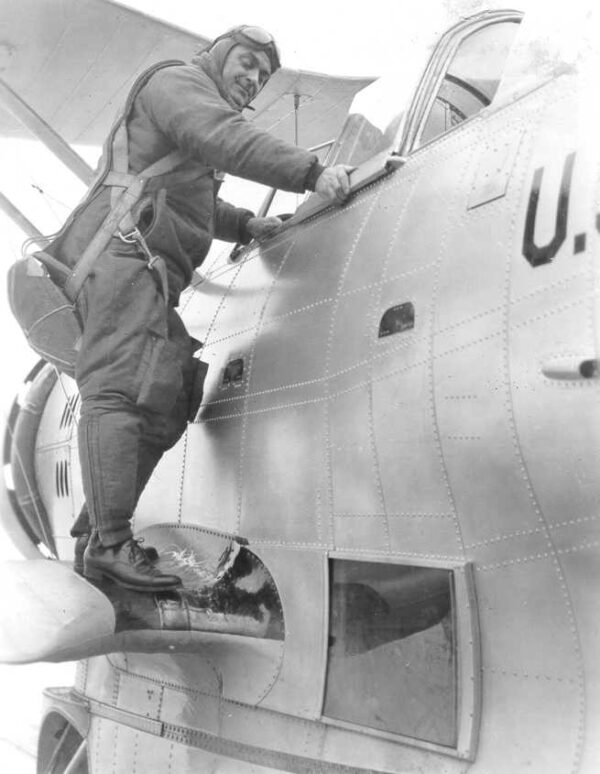 Photo: Elmer Stone climbing into the cockpit of Coast Guard Grumman JF-2 V167.
