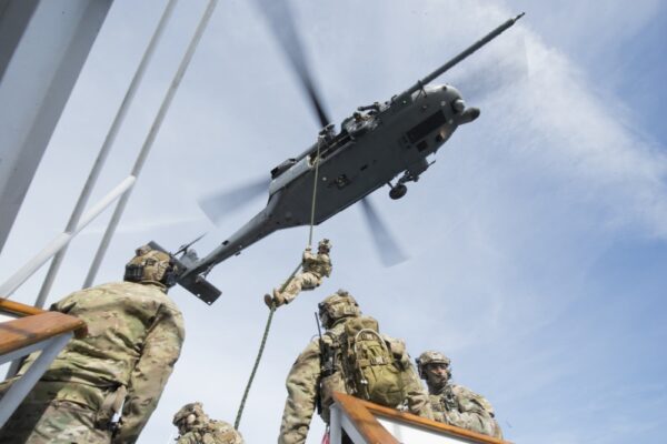 Photo: Members of a Maritime Safety and Security Team during fast-rope training from an Air National Guard helicopter.