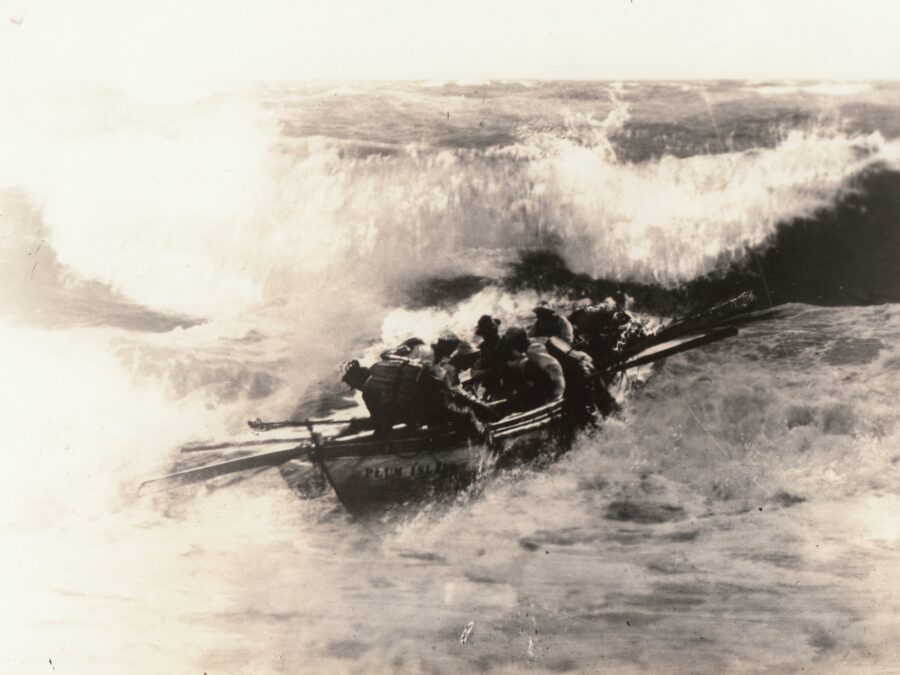 Photo: Rescuers row into heavy waves.