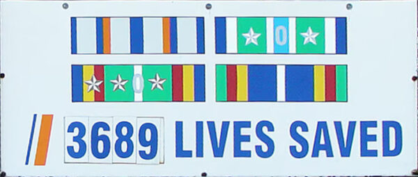 Photo: Air Station New Orleans, LA sign annotated to with 3,689 total lives saved to date.