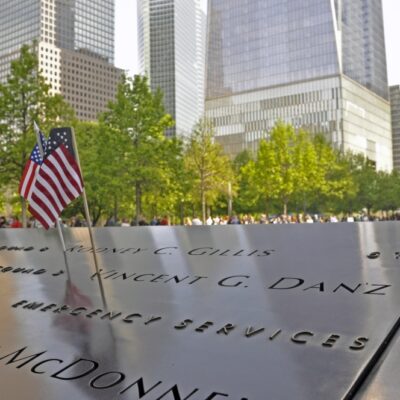 Photo: Memorial with miniature flags and view of downtown Manhattan.