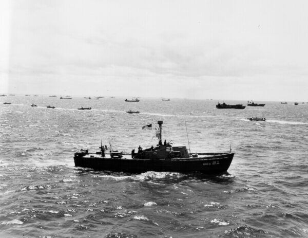 Photo: An 83-foot cutter in the foreground with many ships and other craft in the background.