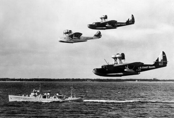 Photo: Three flying life boats in formation above cutter.