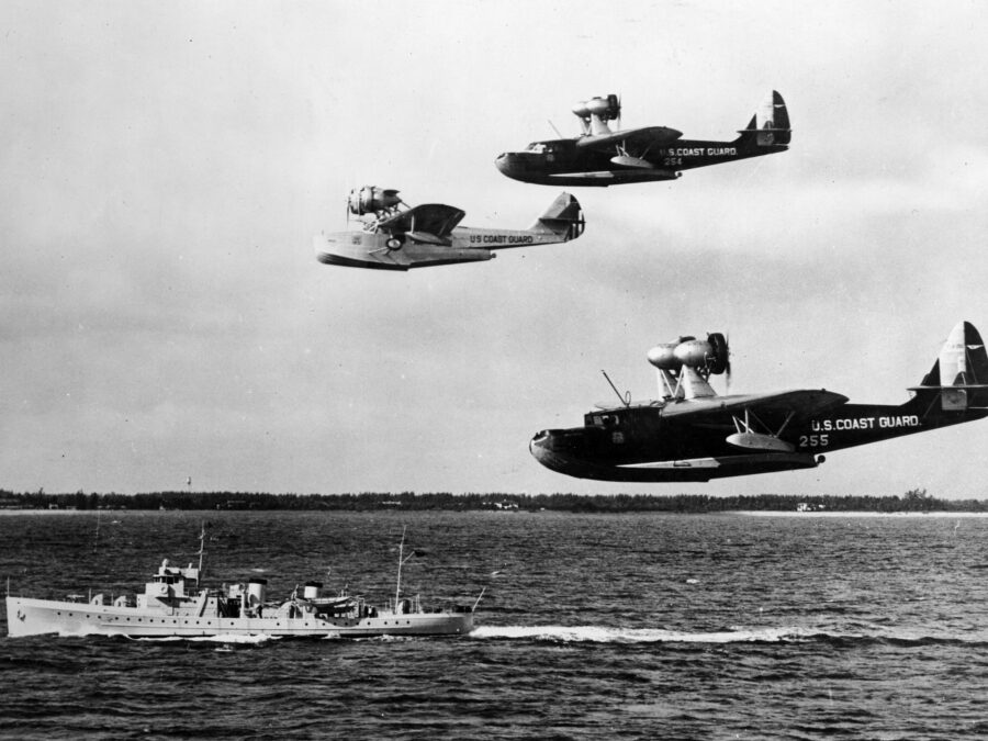 Photo: Three flying life boats in formation above cutter.