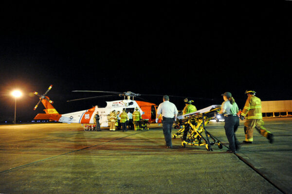 Photo: HH-60 helicopter with fire and emergency services teams.