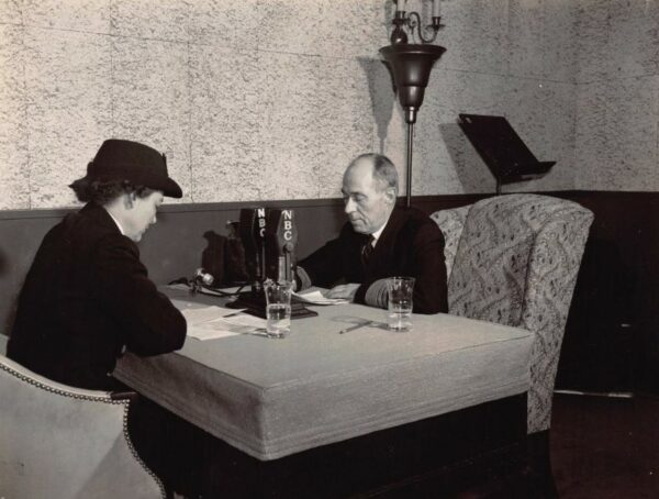 Photo of Dorothy Stratton seated at table with VADM Russell R. Waesche.