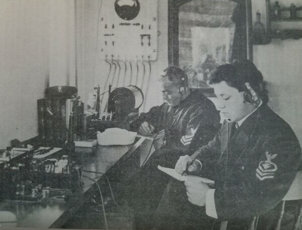 Photo: Radio operators working on messages.