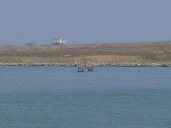Photo: An aid to navigation stands in the water in the distance.