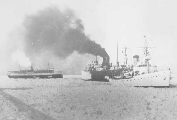 Photo: Cutter Escanaba is breaking ice accompanied by two ferries.