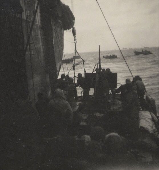 Photo: An 83-footer tied alongside a Navy attack transport to disembark a load of survivors.