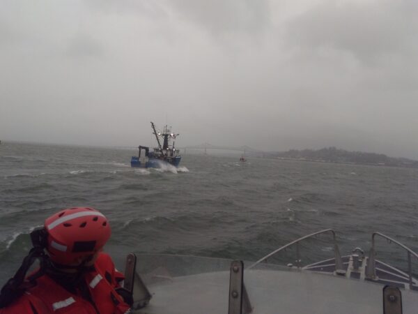 Photo: A blue fishing vessel is in tow in the distance.
