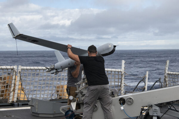 Photo: ScanEagle team members prepare to launch a drone.
