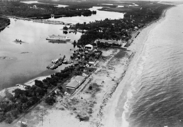 Photo: Aerial view of Coast Guard Base Six showing hangar, patrol boats and beach.