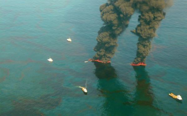 Photo: High altitude view of spilled oil undergoing controlled burns.