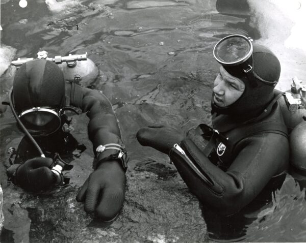 Photo: Two divers surface from the icy water.