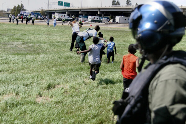 Photo: A U.S. Coast Guard aircrew member watch rescued Hurricane Katrina survivors leave the helicopter in Louisiana, August, 2005.