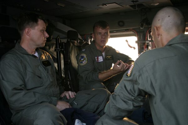 Photo: Coast Guard members on a helicopter during Hurricane Katrina rescue operations.