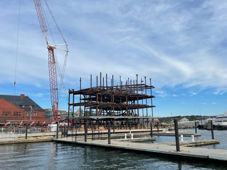 Photo: Dockside view of construction site with crane.