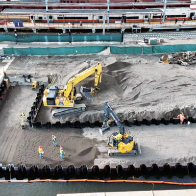 Color aerial view photograph of the National Coast Guard Museum Construction Site taken Aug 2022 during the Bulkhead and Fill process of the project.