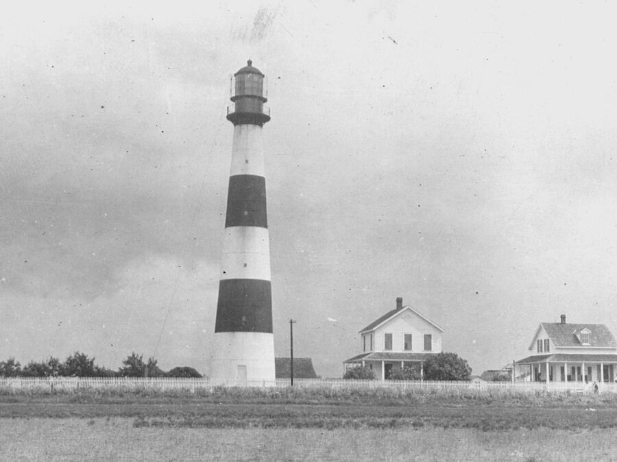 Photo: Bolivar Point Lighthouse and associated houses as seen from the water.