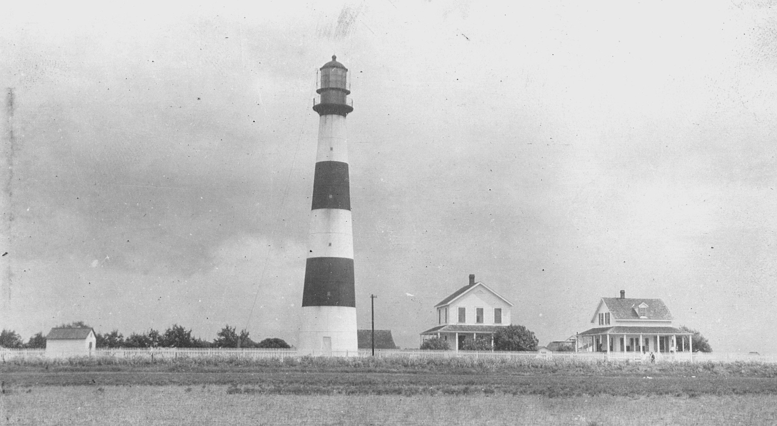 Photo: Bolivar Point Lighthouse and associated houses as seen from the water.